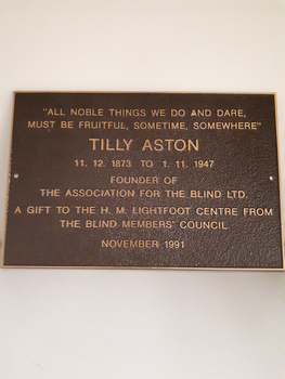 Brown metal plaque with gold writing