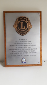 Silver plaque on wooden board with Lions emblem