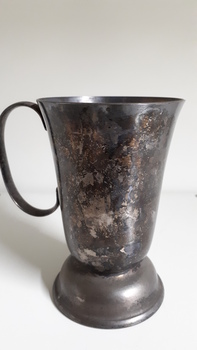 Tarnished silver mug rear view with no badge