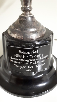 Black plate at base of trophy with white writing
