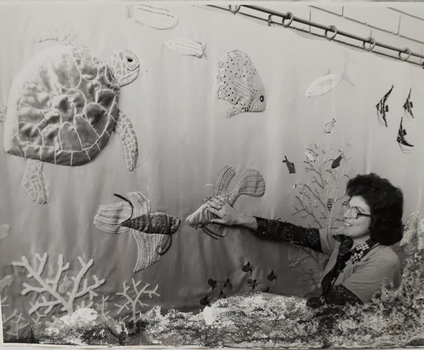 Woman feeling embroidered undersea mural