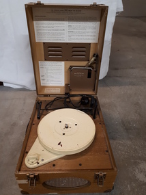 Lid raised to reveal a record player inside the wooden box