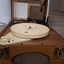 Lid raised to reveal a record player inside the wooden box