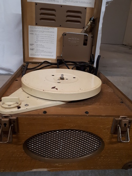 Lid raised to reveal a record player inside the wooden box