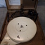 Lid raised to reveal a record player inside the wooden box