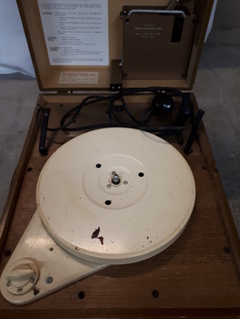 Lid raised to reveal a record player inside the wooden box
