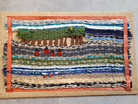 Landscape of trees and houses and river woven on hessian
