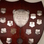 Wooden polished shield with silver nameplates