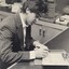 Male using template guide to write on a piece of paper