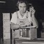 Male using a tool to attach a lid to a box