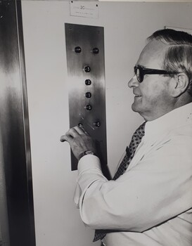 Male pressing elevator buttons