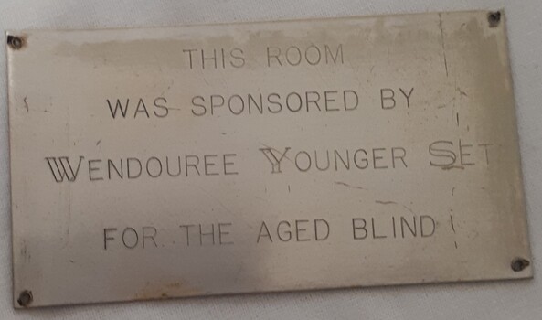 Metal plaque with dedication inscription