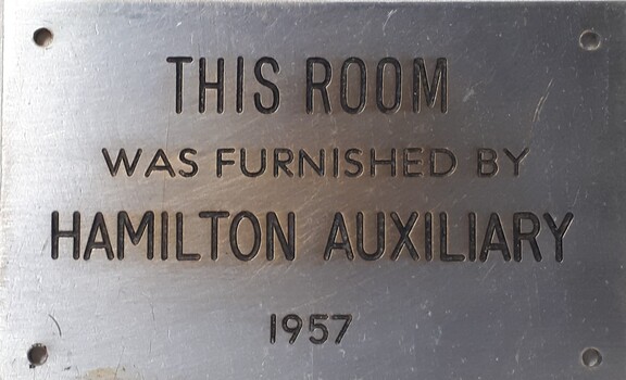 Metal plaque with dedication inscription