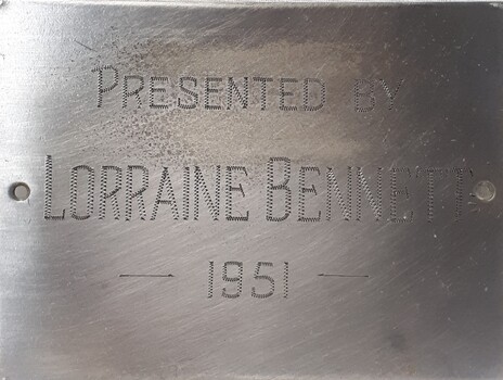 Metal plaque with dedication inscription