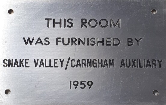 Metal plaque with dedication inscription