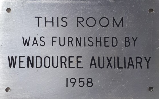 Metal plaque with dedication inscription