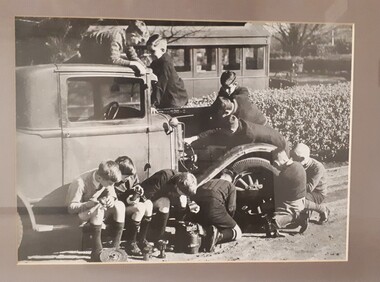 Boys feeling their way around a 1920's car in the front gardens of RVIB