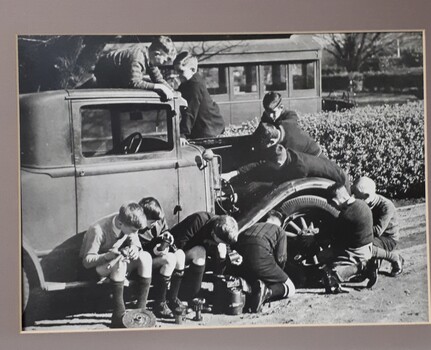 Boys feeling their way around a 1920's car in the front gardens of RVIB