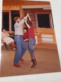 Male and female hold hands above their head and step to the side together
