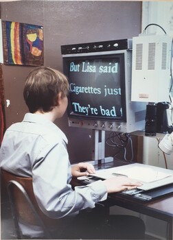 Person seated at a desk using a CCTV 