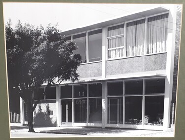 Front of two storey building with large glass windows