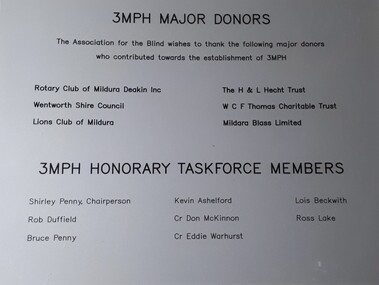 Silver plastic plaque with black writing