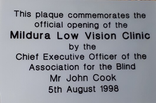 Silver plastic plaque with black writing