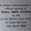 Silver plastic plaque with black writing