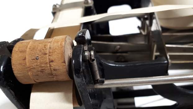 Cork holding paper in place on black metal typewriter