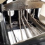 Black metal typewriter which has seven hinges and a small reel of paper