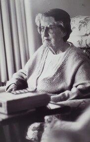 Older woman sitting in a lounge chair