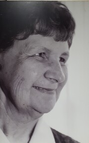 Smiling older female face turning away from camera