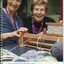 Staff member and day centre participant with a weaving machine