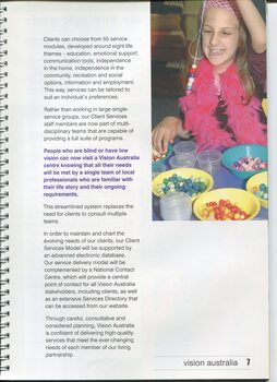 A girl smiles as she holds up a set of beads on a string