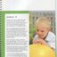 Young boy (Andrew) leaning on a large inflated yellow ball