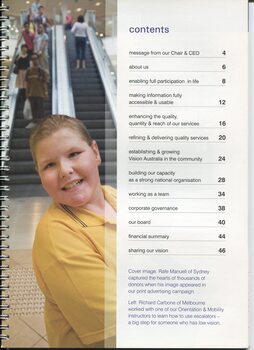 Primary school boy looking towards camera at the base of shopping centre escalators