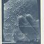 Fingers reading Braille and white writing on grey blue background