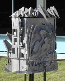 Metal sculpture showing sides depicting Decay, Ruin and Harmony
