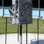 Metal sculpture showing sides depicting Decay, Ruin and Harmony