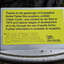 Yellow and blue sign providing name of artist, sculpture and person who commissioned it in writing and Braille