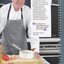 Brett O'Neil in a chef's uniform in a commercial kitchen