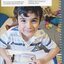 A young boy, Sam, holds a pocket magnifier over a book in his bedroom