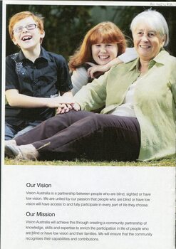 Two red haired children, Hayden and Lily, smile as they kneel next to an older lady