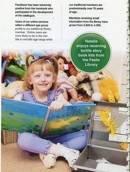Natalie, a young child, holds a print Braille book next to the Feelix kit in her bedroom