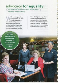 Two woman sit at a table at the Illawarra Leagues Club, one reading Braille menu, the other large print, with two other woman looking on