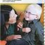 Young boy, Oscar, touches his shirt buttons as his mother Melissa tickles him