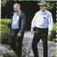Two men, one with a white cane, walk along a path at the Gosford Regional Gallery and Japanese Gardens