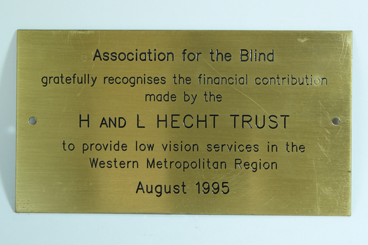 Gold coloured metal plaque with black writing