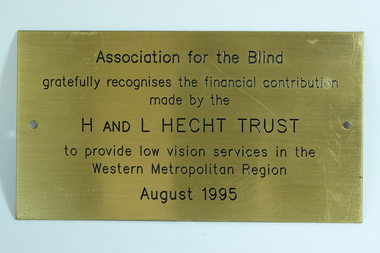 Gold coloured metal plaque with black writing