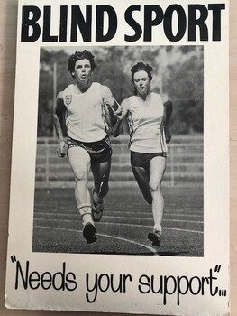 Two people running on athletic track holding a tether between them